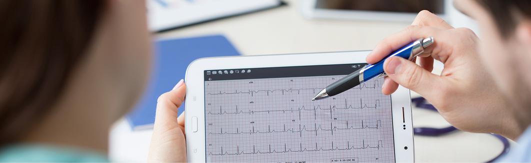 Professionisti sanitari discutono davanti ad un elettrocardiogramma su un tablet